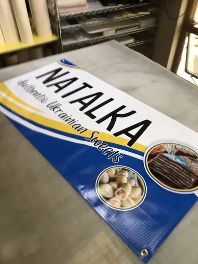 Blue and yellow printed name banner on a production table