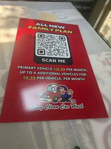 Red promotional sign with a QR code