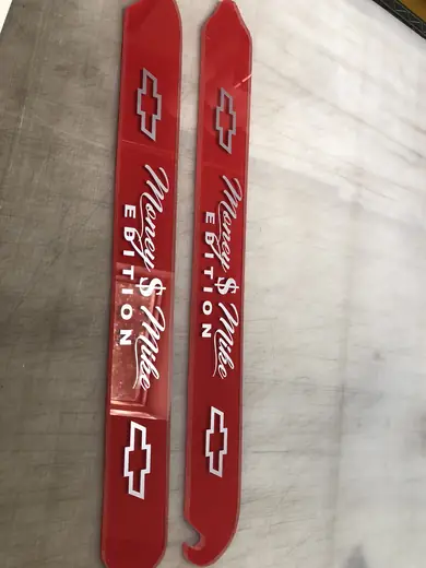 Long red printed vinyl strips laid out for trimming